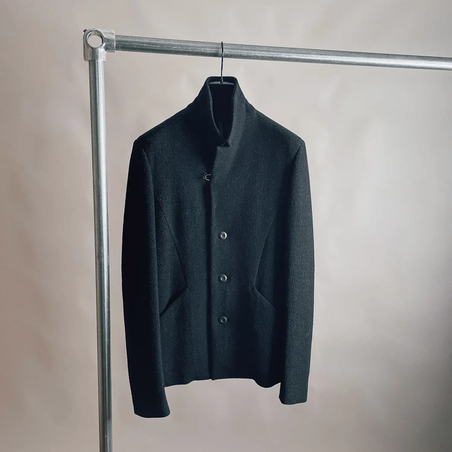 Black knit jacket on hanger, Attachment by Kazuyuki Kumagai