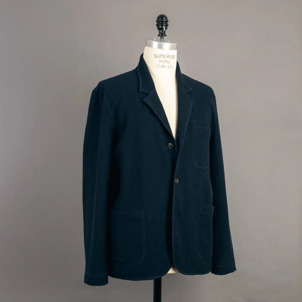 Felted chore jacket from Buck Mason, navy, on a dummy