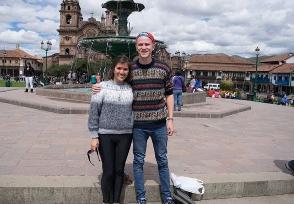 Tourists shop for colorful sweaters in Cusco, Peru