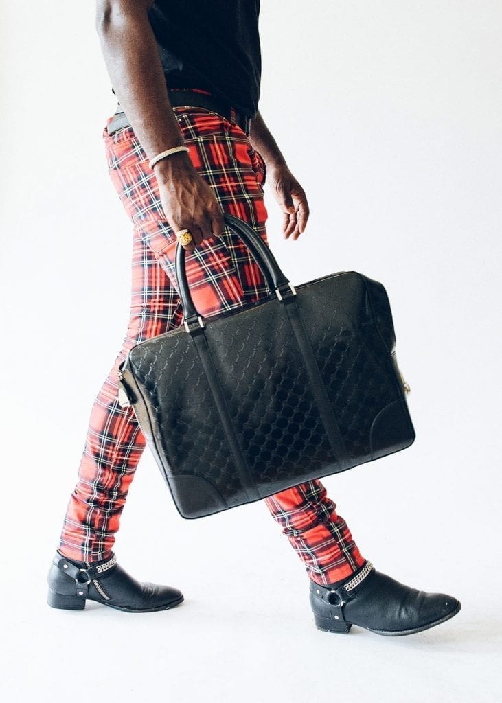 guy with red plaid pants and black luxury briefcase
