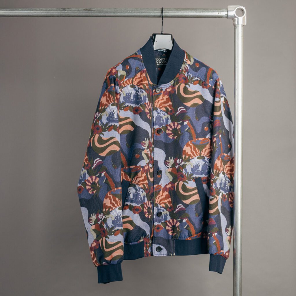colorful jacquard bomber jacket by scotch and soda on hanger
